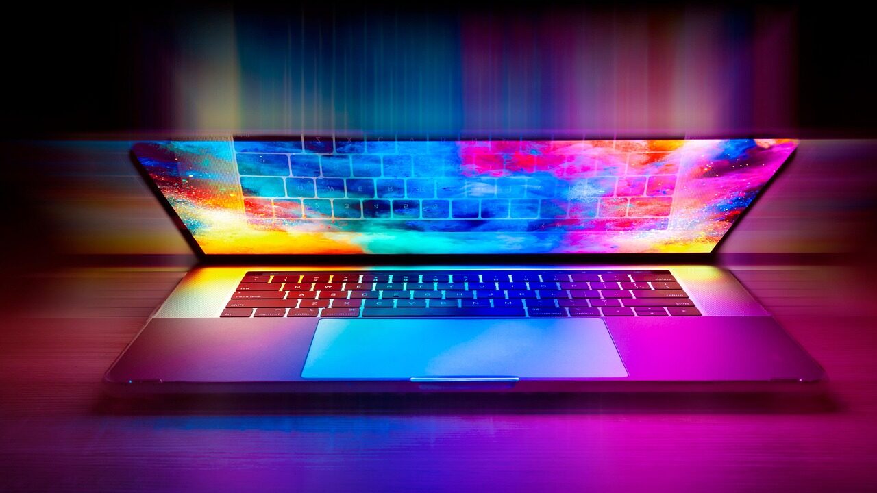 Colourful illuminated laptop keyboard representing a late-night search, header image for blog post on pornography law in Singapore